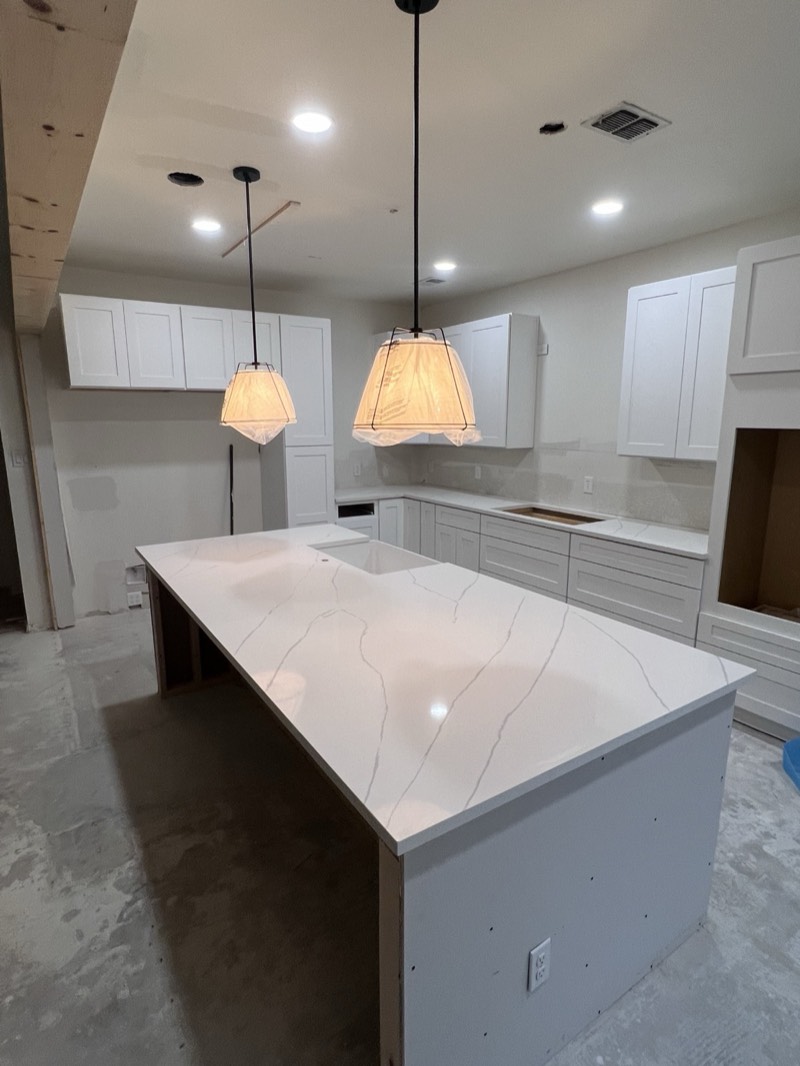 Bright white shaker kitchen with island and pendant lighting