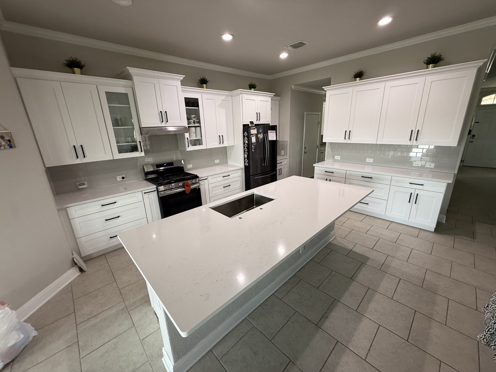 Bright white shaker kitchen with a large quartz island, designed and installed by MNK Cabinet in metro Atlanta