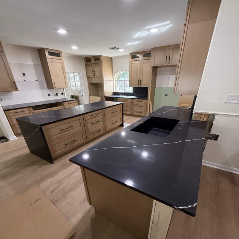 Natural maple shaker kitchen with a large island by MNK Cabinet